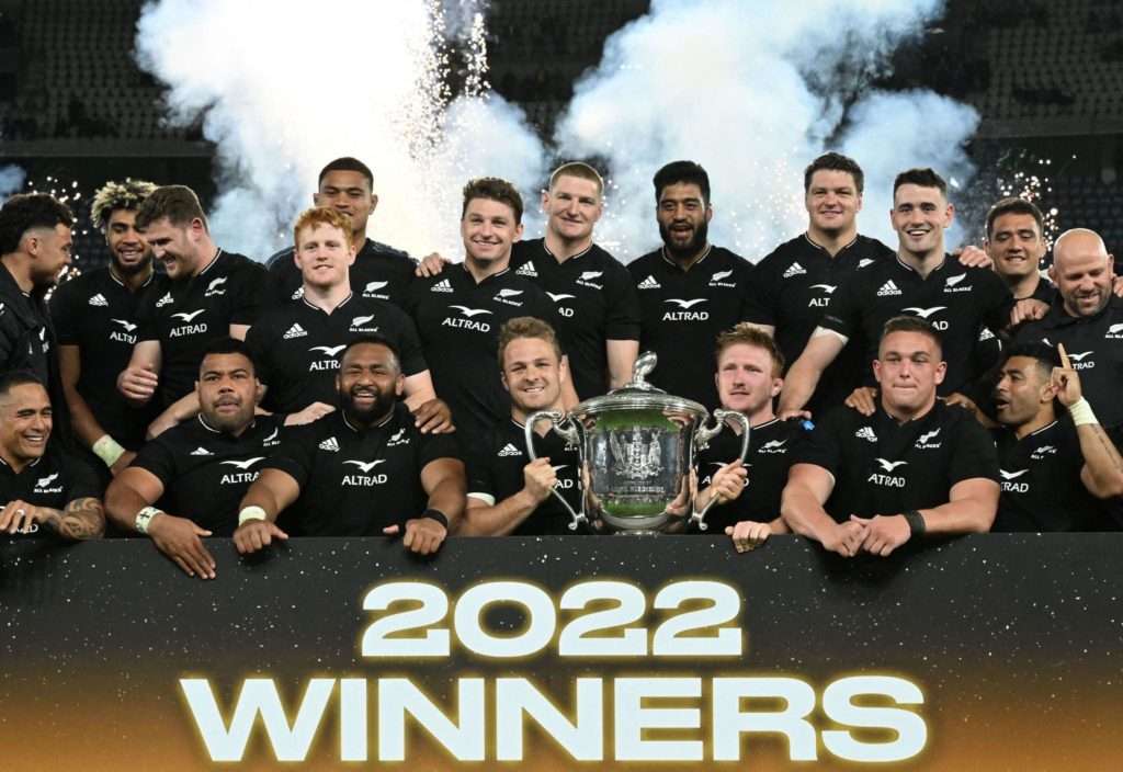 New Zealand's players celebrate with the trophy after winning the Rugby Championship after their match against Australia at Marvel Stadium in Melbourne